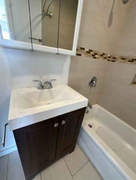 A white sink with a chrome faucet is installed in a white countertop.
